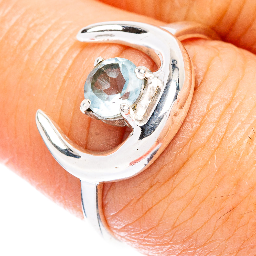 Silver moon dainty ring with oval blue topaz-style stone, prong setting