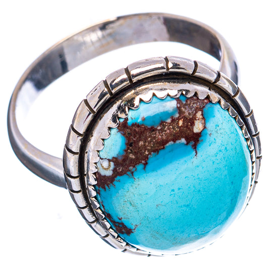 Sterling silver adjustable ring with oval turquoise cabochon and patterned shank.