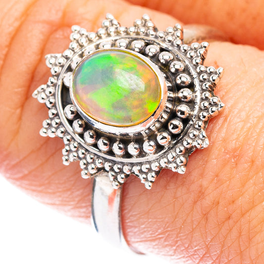 Sterling silver opal ring, oval green-orange Ethiopian opal center with beaded halo.