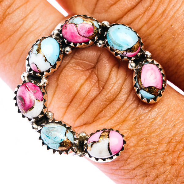 Naja-style ring with turquoise, pink, and white oval gemstones on silver setting