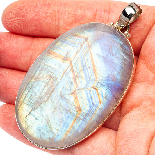 Oval rainbow moonstone pendant with .925 sterling silver bail, iridescent white-blue glow