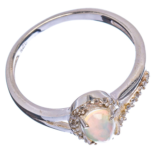 Oval opal-style gemstone ring with cubic zirconia halo on sterling silver band