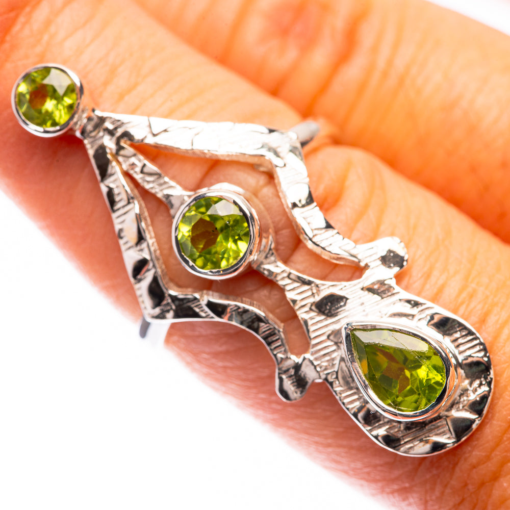 Sterling silver peridot ring with three round green gemstones, openwork design