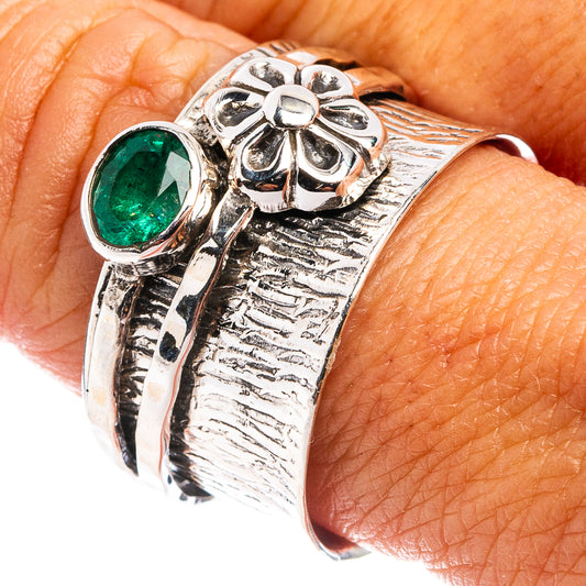 Sterling silver ring with oval green gemstone and ornate petal-shaped setting