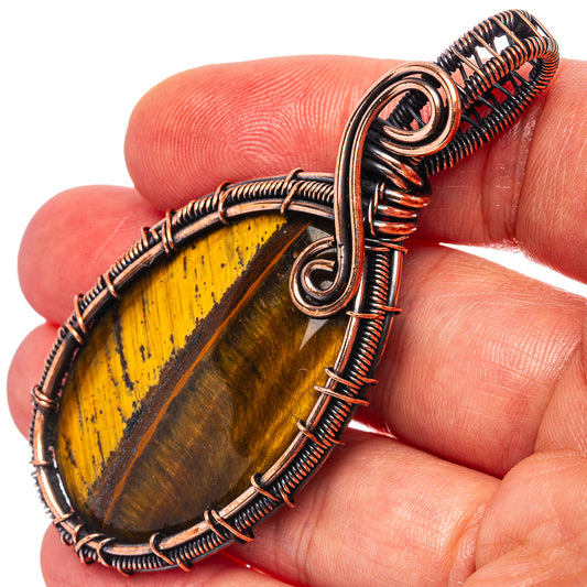 Oxidized copper wire-wrap pendant with oval tiger eye stone and looping bail