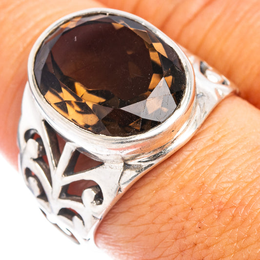 Sterling silver smoky quartz ring with dark oval gemstone, ornate etched band.