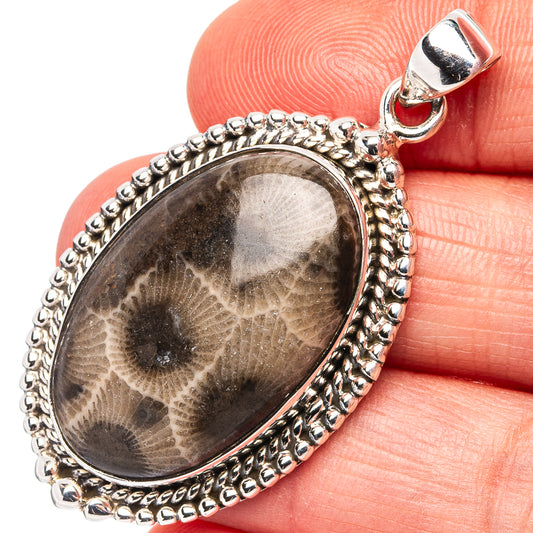 Sterling silver oval pendant with dark fossil coral stone and beaded bezel setting