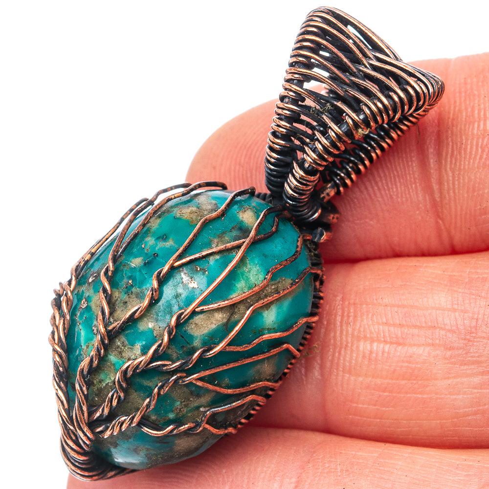 Turquoise stone pendant with oxidized copper wire wrap, tree of life pattern detail