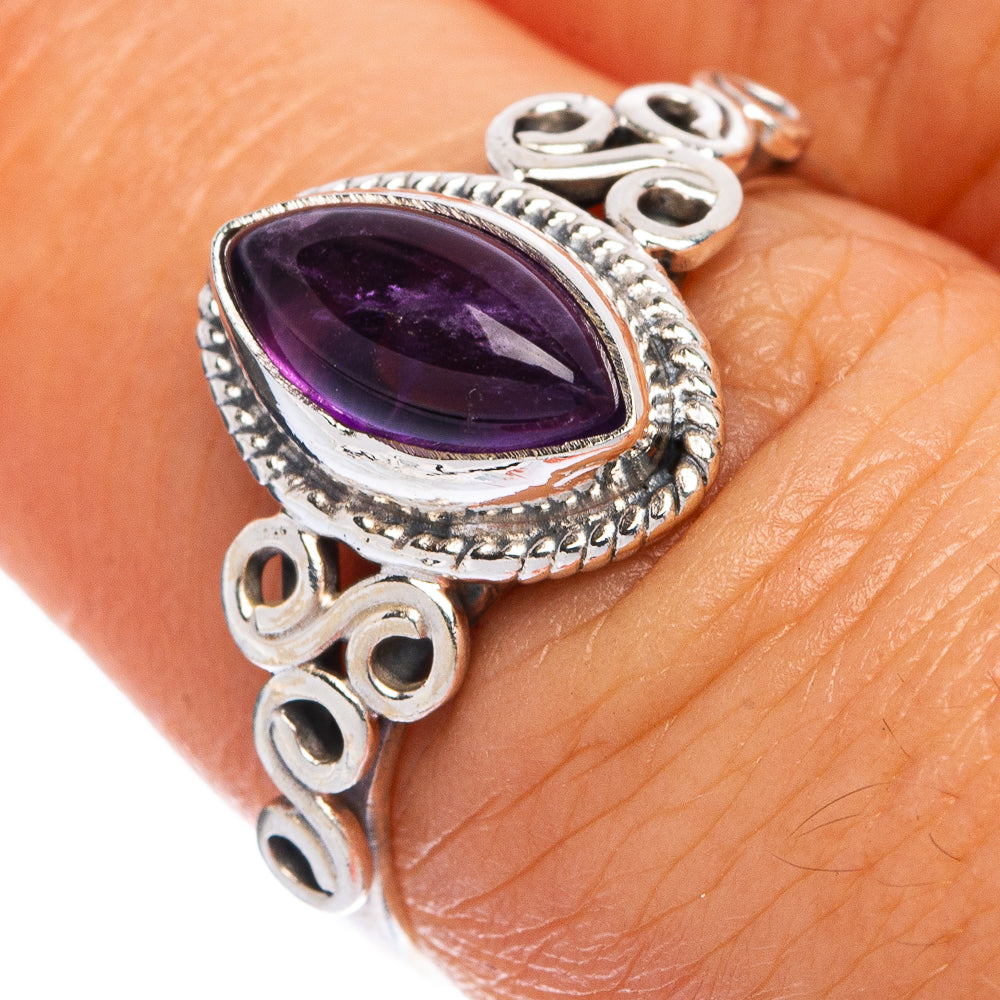 Oval amethyst pendant-style sterling silver ring with ornate bezel and circular cutouts