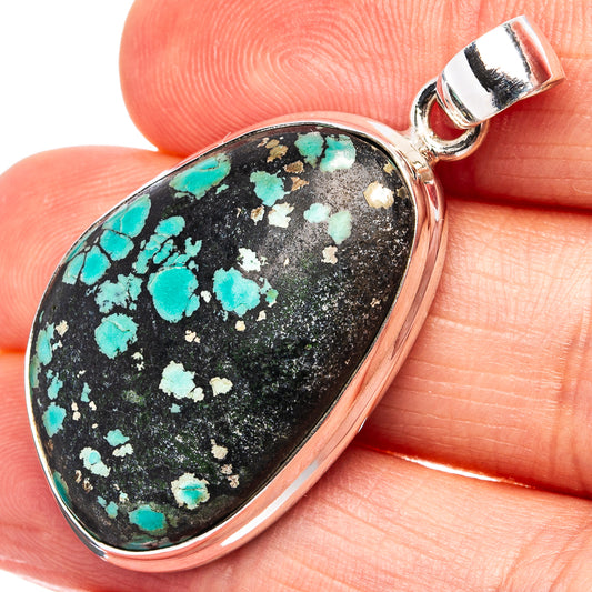 Turquoise pendant on black stone with .925 sterling silver bezel and bail