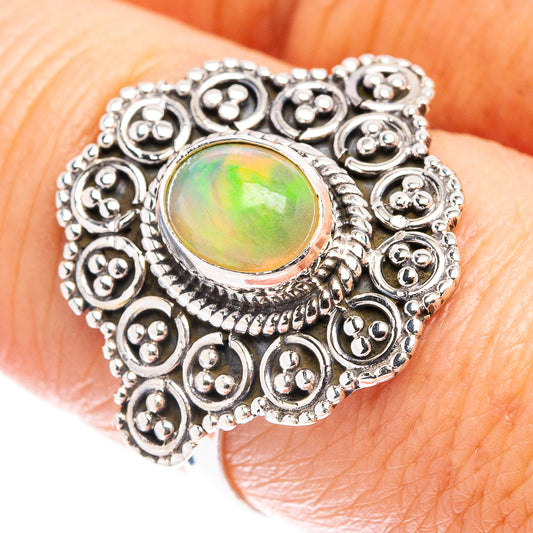 Sterling silver opal ring with round green gemstone center and ornate bezel