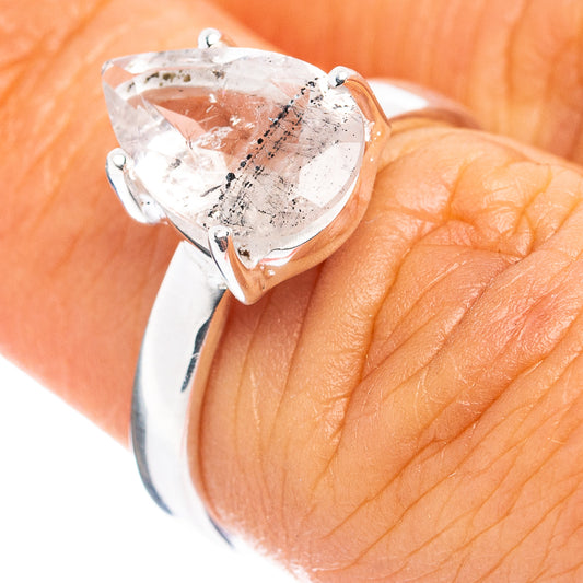 Sterling silver ring with pear-cut clear tourmalinated quartz center stone