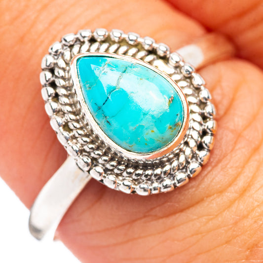 Turquoise cabochon sterling silver ring with bead-textured halo