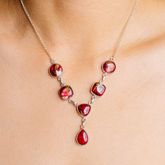 Sterling silver necklace with red teardrop charm cluster and heart accents