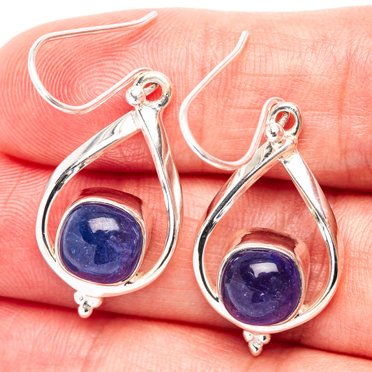 Sterling silver teardrop earrings with blue tanzanite-style gemstones and curved hook backs
