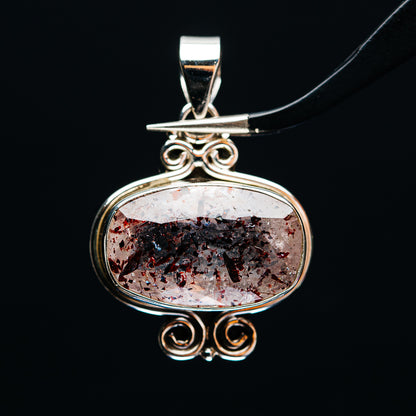 Oval lepidocrocite pendant in .925 sterling silver bezel with scrollwork bail and openwork details
