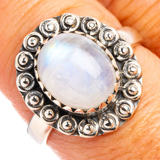 Sterling silver moonstone ring with round iridescent stone and ornate circular bezel detail