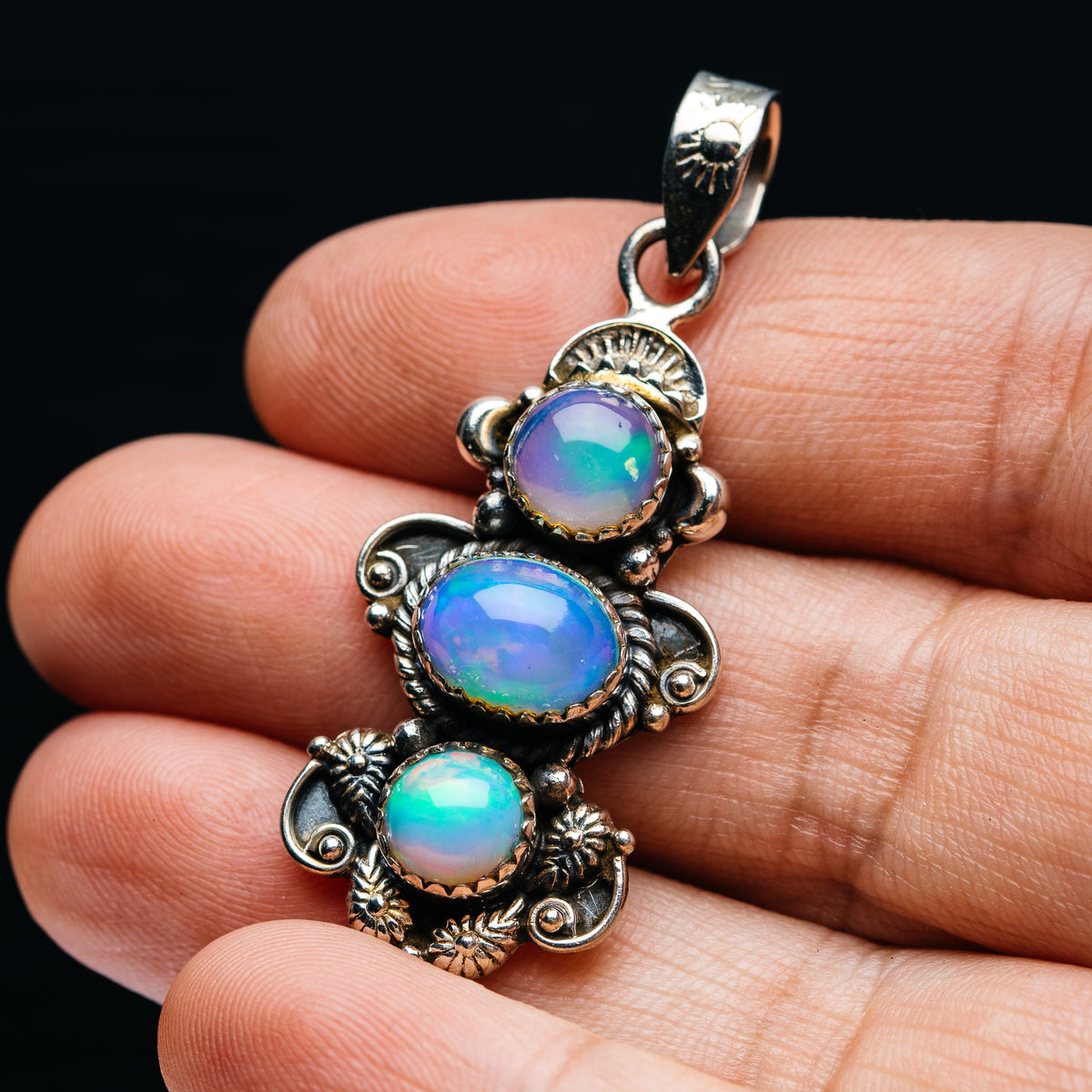 Sterling silver pendant with three round opal gems and floral filigree settings