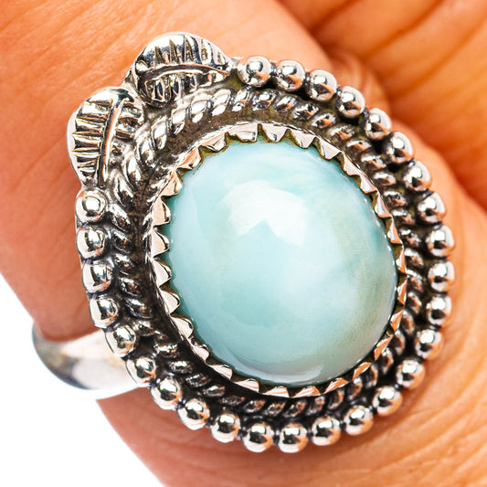 Sterling silver ring with oval light blue larimar center and beaded halo setting
