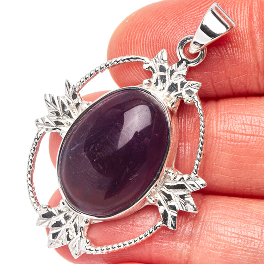 Oval amethyst pendant in .925 sterling silver with ornate bezel and star accents