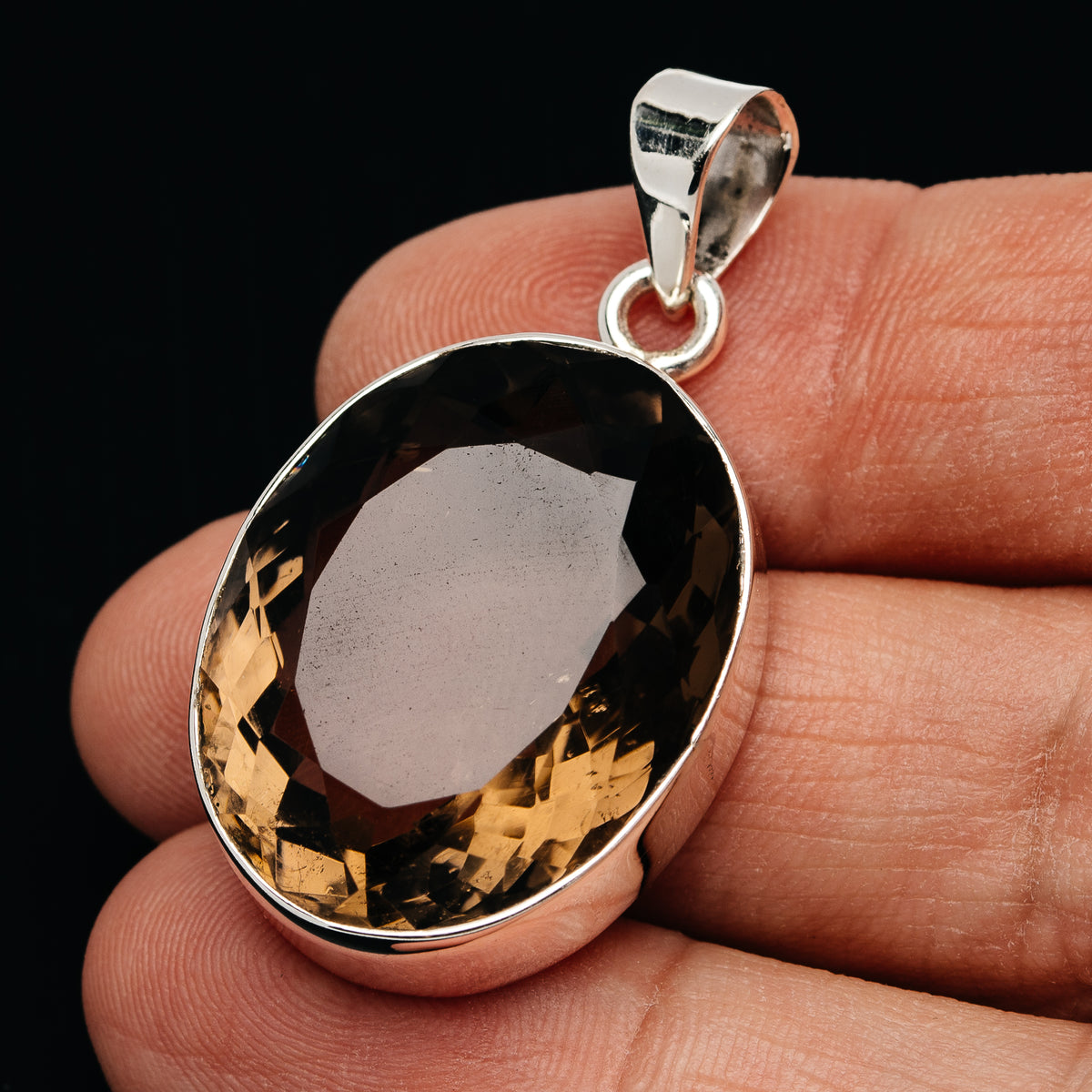 Sterling silver smoky quartz pendant with oval faceted dark stone and bail