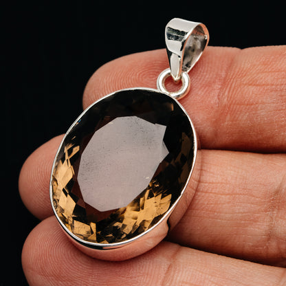 Sterling silver smoky quartz pendant with oval faceted dark stone and bail