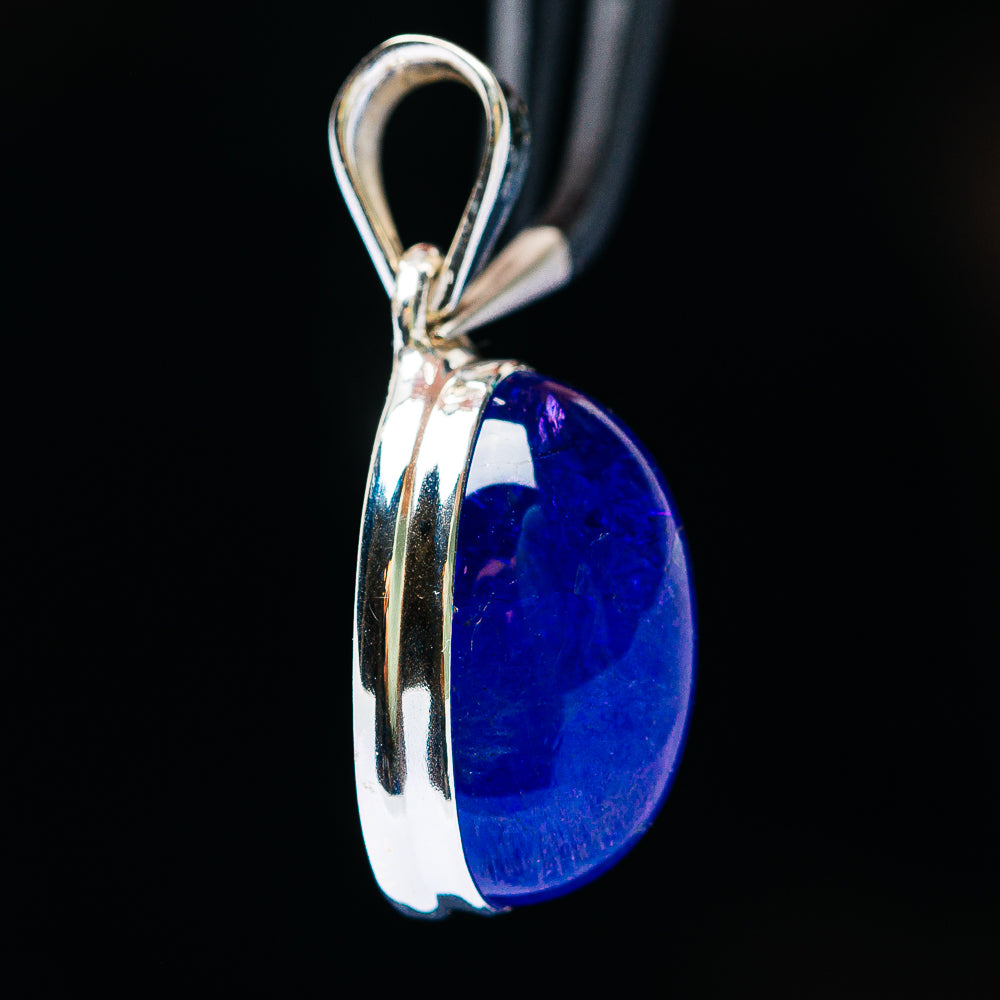 Side view of oval blue tanzanite pendant in .925 sterling silver with bail and prongs