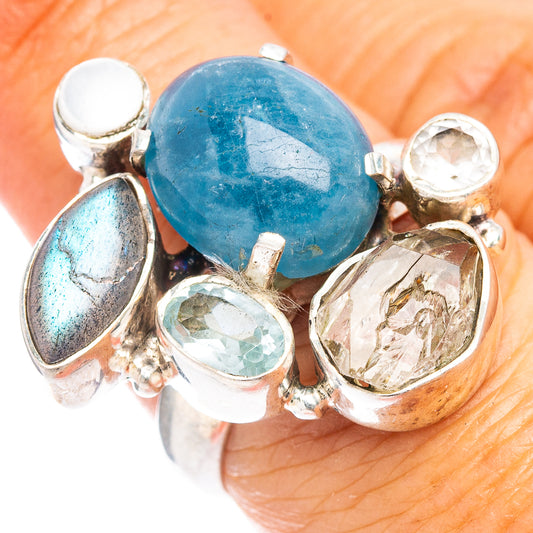 Sterling silver ring with large blue oval gemstone and three clear stones