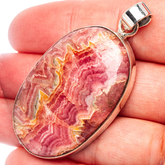 Oval rhodochrosite pendant in .925 sterling silver with textured red stone face