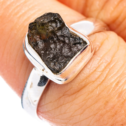 Sterling silver ring on finger, bezel-set dark green rough stone