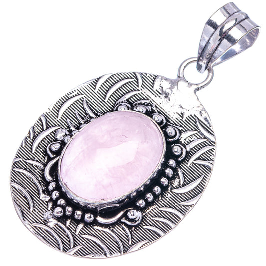Ornate German silver rose quartz pendant with oval pink cabochon and textured leaf frame