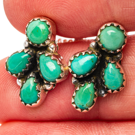 Close-up of sterling silver turquoise cluster earrings with five oval and round stones