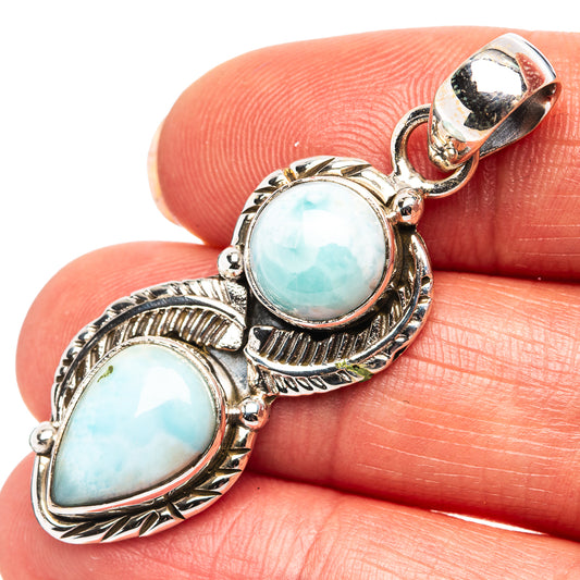 Sterling silver larimar pendant with two oval light-blue stones, ornate bezel and bail