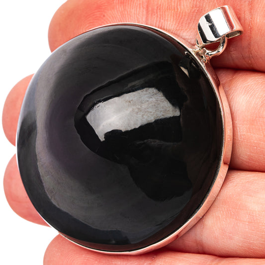 Glossy black round obsidian pendant with polished .925 sterling silver bezel and loop bail