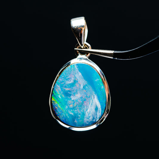 Sterling silver fire opal pendant with teardrop blue-green cabochon, bezel setting