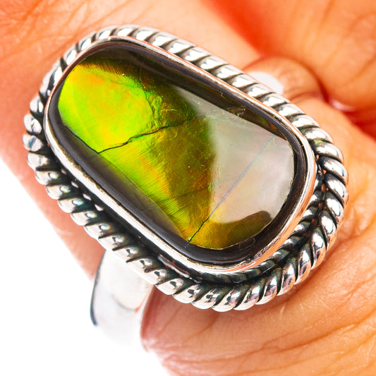 Oval ammolite ring in silver with iridescent green and yellow center stone.