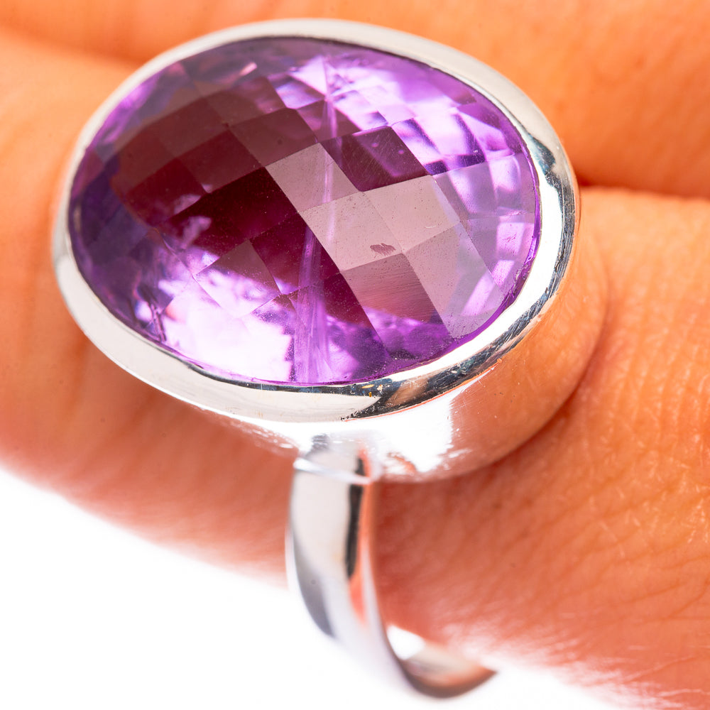 Sterling silver ring with large oval faceted amethyst, bezel-set stone with glossy facets