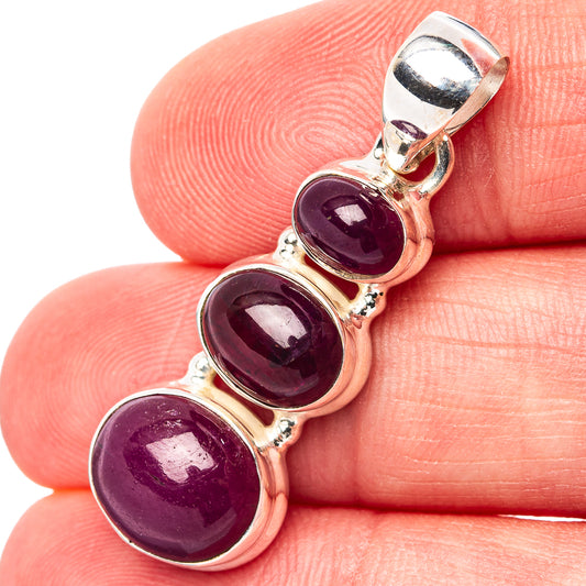 Three oval ruby cabochon pendant with sterling silver bezel and hinged bail.