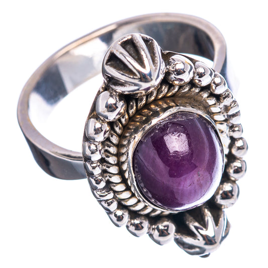Sterling silver adjustable ring with purple oval ruby cabochon and carved star accents