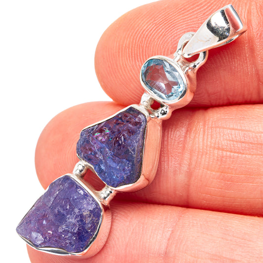 Sterling silver pendant with round blue topaz and three tanzanite cabochons