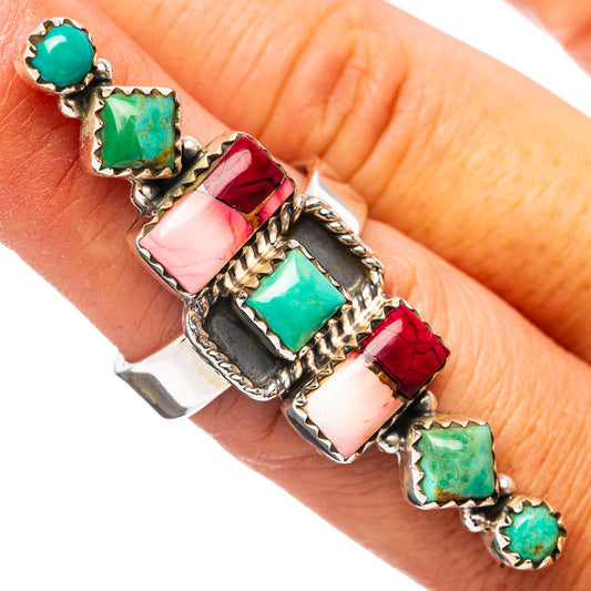 Ornate adjustable sterling silver ring with turquoise squares and red bands on hand
