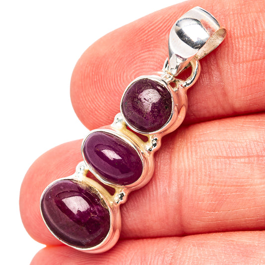 Three-stone ruby pendant with oval purple-red cabochons in .925 sterling silver setting