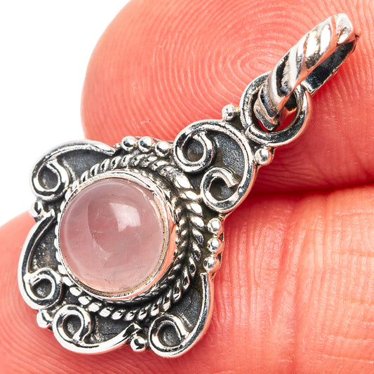 Sterling silver rose quartz pendant with round pink stone and ornate filigree frame