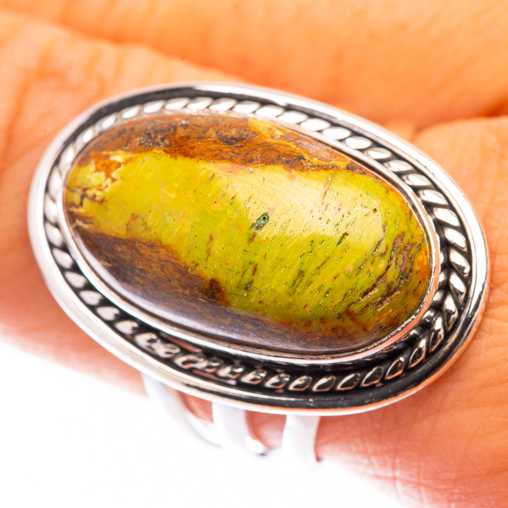 Sterling silver oval cabochon ring with green-yellow Gaspeite and ornate bezel