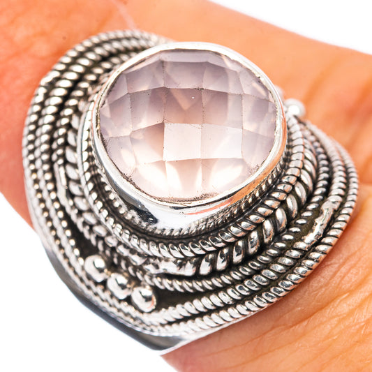 Sterling silver ring with oval rose quartz center stone and ornate braided band