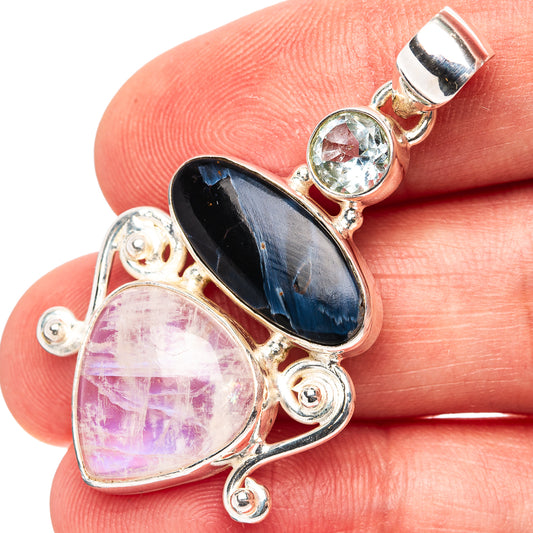 Sterling silver pendant with dark oval and pink oval gemstones, plus round light stone