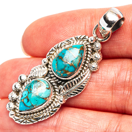 Turquoise oval pendant in .925 sterling silver with textured leaf frame, charm top