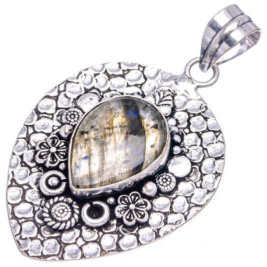 Labradorite teardrop-oval pendant with ornate German silver texture, floral details, loop bail