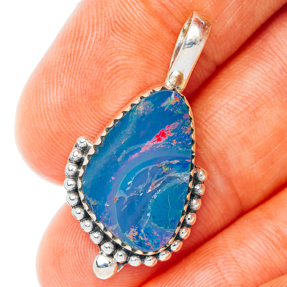 Sterling silver opal pendant with teardrop blue stone and red flecks, ornate bezel