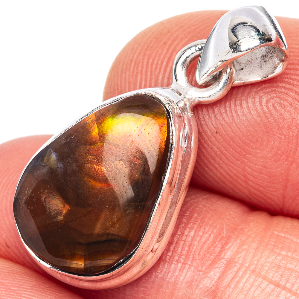 Sterling silver fire agate teardrop pendant with dark amber-orange stone, close-up